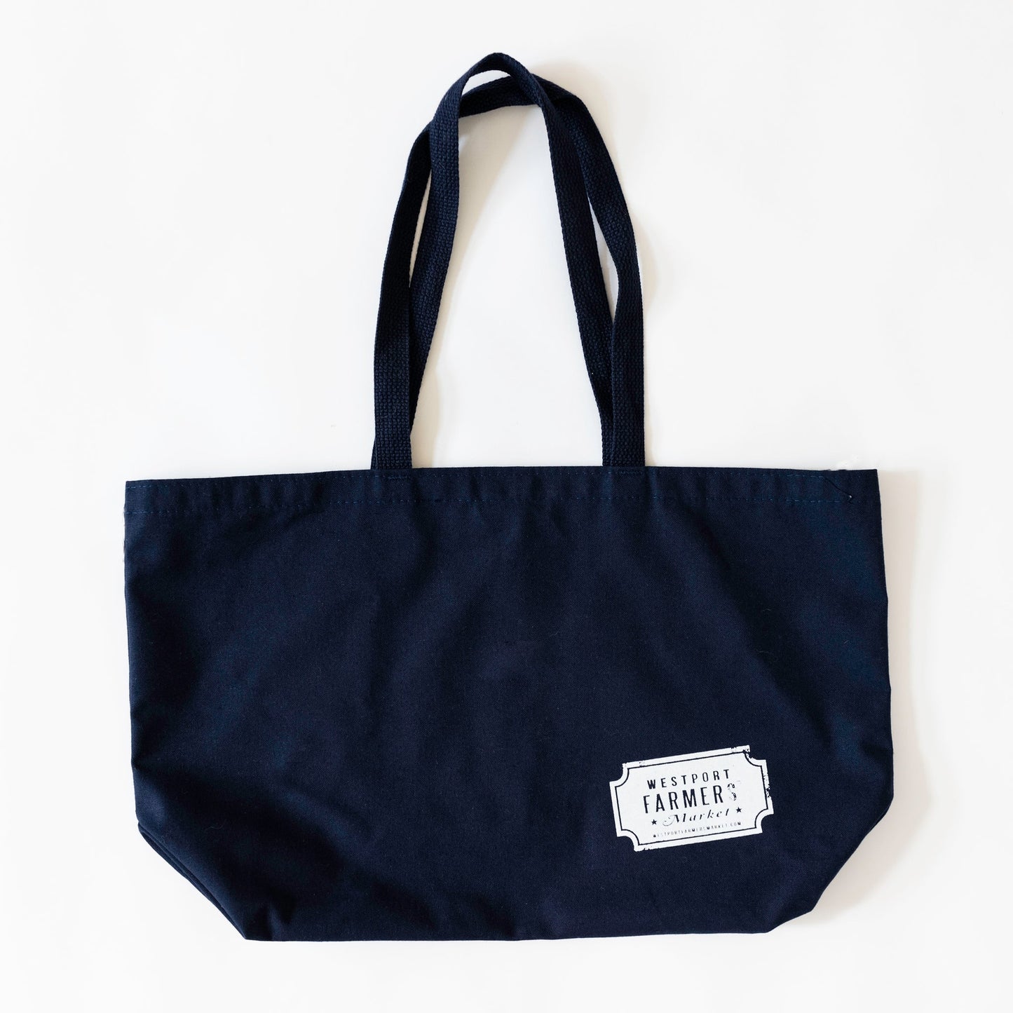 Navy tote bag back with westport farmers' market logo printed on bottom right